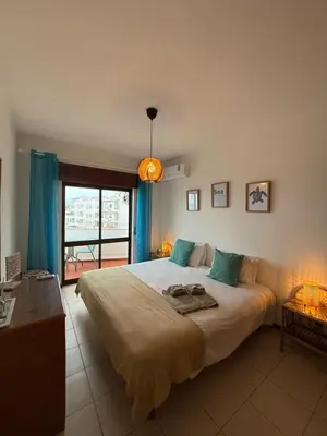 a bedroom with a large bed and a window at Olimar Sea View Apartment in Albufeira
