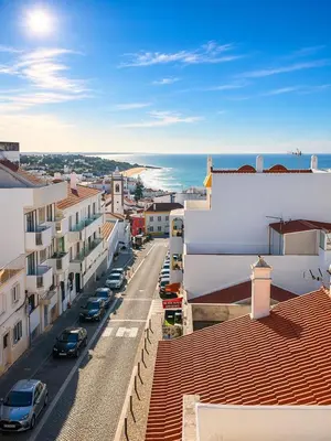 a bedroom with a large bed and a mirror at Olimar Sea View Apartment in Albufeira