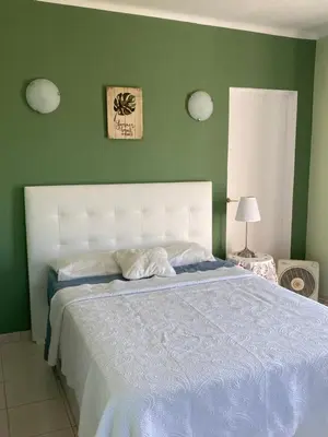 a bedroom with a large bed with a blue blanket at casa da ainheira 44 cruz da assumada 8100-296 Loulé in Loulé