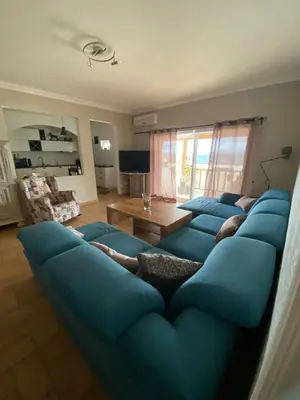a living room with a blue couch with people laying on it at casa da ainheira 44 cruz da assumada 8100-296 Loulé in Loulé
