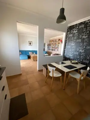 a dining room with a table and chairs and a chalkboard at casa da ainheira 44 cruz da assumada 8100-296 Loulé in Loulé
