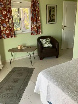 a bedroom with a couch and a table and a chair at casa da ainheira 44 cruz da assumada 8100-296 Loulé in Loulé