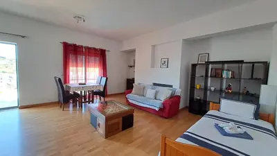 a living room with two beds and a couch and a table at Albufeira Marina Penthouse 1 in Albufeira