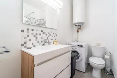 a white bathroom with a sink and a toilet at Villa Magna - Apt- 206 by HelloVacations in Albufeira