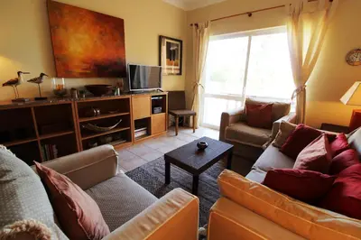 a living room with two couches and a tv at Apt T2 Jardins do Castelo - Albufeira, Algarve in Albufeira