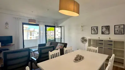 a living room with a white table and chairs at Medronheira by Check-in Portugal in Albufeira