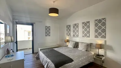 a bedroom with a large bed and a window at Medronheira by Check-in Portugal in Albufeira