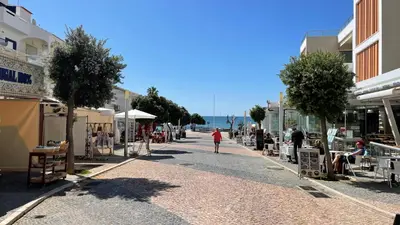 a street with shops and people walking down a street at Medronheira by Check-in Portugal in Albufeira