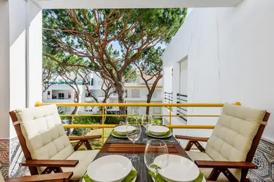 a balcony with a table and two chairs at Aldeia das Açoteias Apartment in Roja- Pé