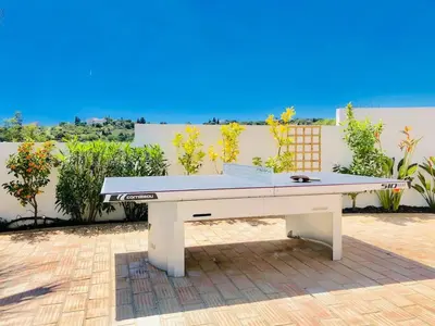 a bed in a room with a window at Luxury Casa da Fonte - Private Heated Salt Pool in Faro