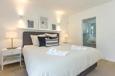 a bedroom with a bed with two towels on it at Villa Casinha in Albufeira