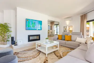 a living room with a couch and a fireplace at Villa Casinha in Albufeira
