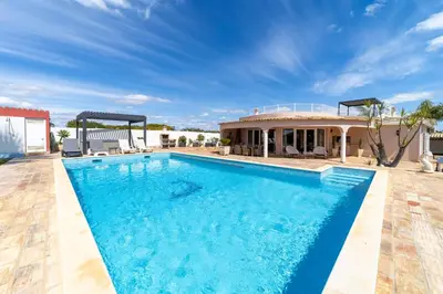a swimming pool in front of a house at Villa Dolce Vita in Albufeira