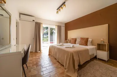 a hotel room with a bed and a window at Villa Dolce Vita in Albufeira