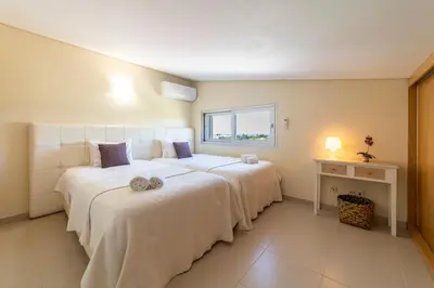 a bedroom with two beds and a window at Villa Maria in Albufeira