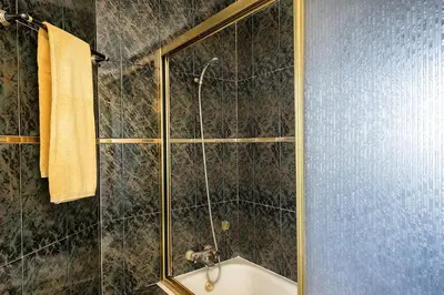 a bathroom with a shower with a glass door at Villa Solar das Palmeiras in Albufeira