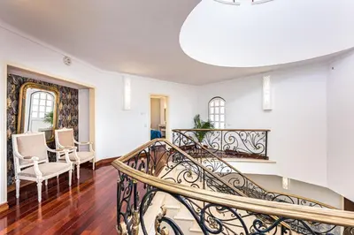 a staircase in a living room with a stair case at Villa Solar das Palmeiras in Albufeira