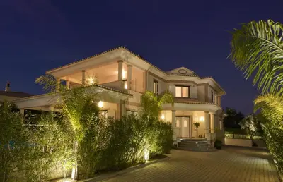 a large white house at night with lights at Villa Cor de Rosa in Albufeira