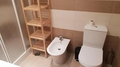 a small bathroom with a toilet and a sink at Quinta do Pinheiro Residence in Albufeira