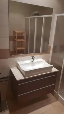 a bathroom with a white sink and a mirror at Quinta do Pinheiro Residence in Albufeira