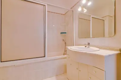 a white bathroom with a sink and a shower at Rei - Quarteira - 3 min to the beach in Vilamoura