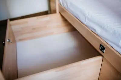 a bed with a wooden drawer in a room at DREAMS HOUSE in Faro