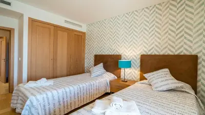 a bedroom with two beds and a blue lamp at Marina Vilamoura - Aquamar 120 - By Vilamoura Sun in Vilamoura