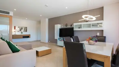 a kitchen and living room with a table and a couch at Marina Vilamoura - Aquamar 120 - By Vilamoura Sun in Vilamoura