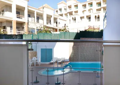 a view from the balcony of a building with a swimming pool at Apt Baleeira Sol in Albufeira