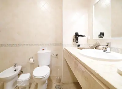 a bathroom with a toilet and a sink at Apt Baleeira Sol in Albufeira