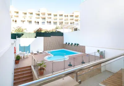 a balcony with a swimming pool and a building at Apt Baleeira Sol in Albufeira