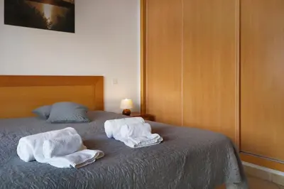 a bedroom with two towels on a bed at Apt Baleeira Sol in Albufeira