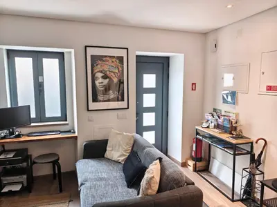 a living room with a couch and a television at The Old Town House by Freetimealgarve in Faro