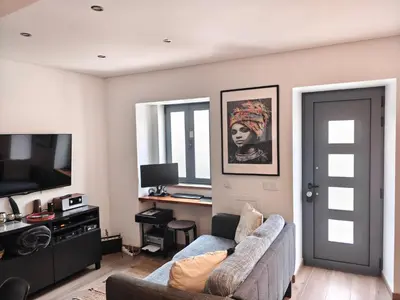a living room with a couch and a television at The Old Town House by Freetimealgarve in Faro