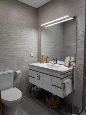 a bathroom with a sink and a toilet and a mirror at The Old Town House by Freetimealgarve in Faro