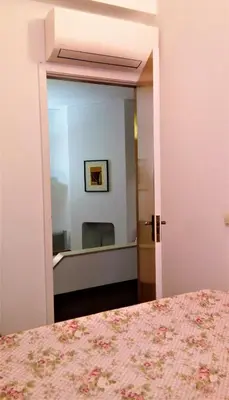 a bedroom with a mirror and a bed at Sunny Apartment Close to the Beach in Albufeira