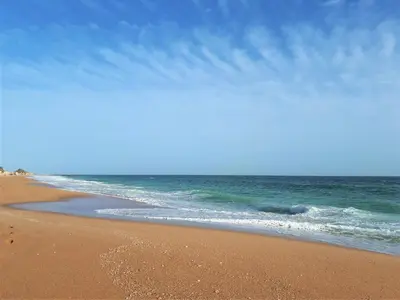 a beach with the ocean and a blue sky at Sunny Apartment Close to the Beach in Albufeira