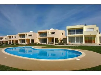 a large building with a large pool in front of it at Villas Oceano in Albufeira