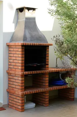 an outdoor brick pizza oven sitting on a patio at Villas Oceano in Albufeira