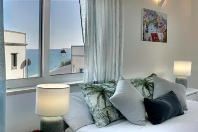 a living room with a couch and a large window at CASA 4 - Perfect location - Sea view by DreamvillasAlbufeira in Albufeira