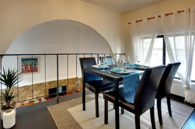 a dining room with a blue table and chairs at CASA 4 - Perfect location - Sea view by DreamvillasAlbufeira in Albufeira