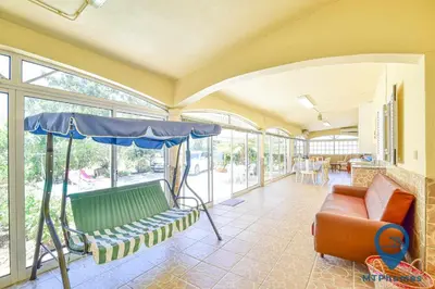 a living room with a couch and an umbrella at Vila Portuguesa by MTPhomes in Albufeira