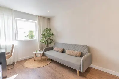 a living room with a couch and a table at Old Town Apartment 5min to the beach in Albufeira