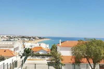 a view of a city with the ocean in the background at Old Town Apartment 5min to the beach in Albufeira