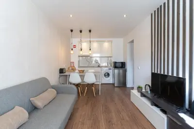 a living room with a couch and a television in it at Old Town Apartment 5min to the beach in Albufeira