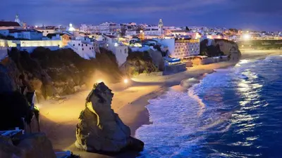 a view of a beach at night with buildings at Apartment MargemSul - Pool - Beach - Free Wifi - Air Con in Albufeira