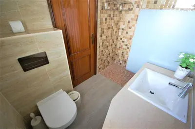 a bathroom with a white toilet and a sink at Apartment MargemSul - Pool - Beach - Free Wifi - Air Con in Albufeira