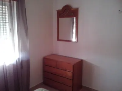 a bedroom with a dresser and a mirror on the wall at Albufeira 2 bedroom apartment 5 min from Falesia beach and close to center I in Albufeira