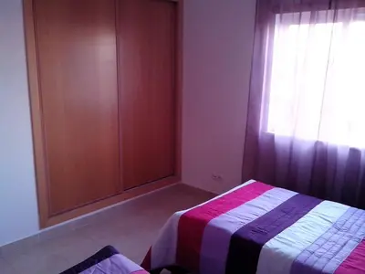 a bedroom with a bed and a window with curtains at Albufeira 2 bedroom apartment 5 min from Falesia beach and close to center I in Albufeira