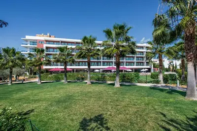 a sign in front of an office building at Areias Village Beach Suite Hotel in Albufeira